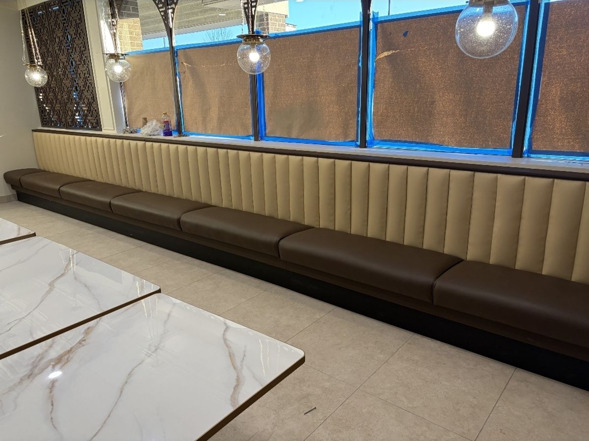 Coffee shop tan channel-back booth seating